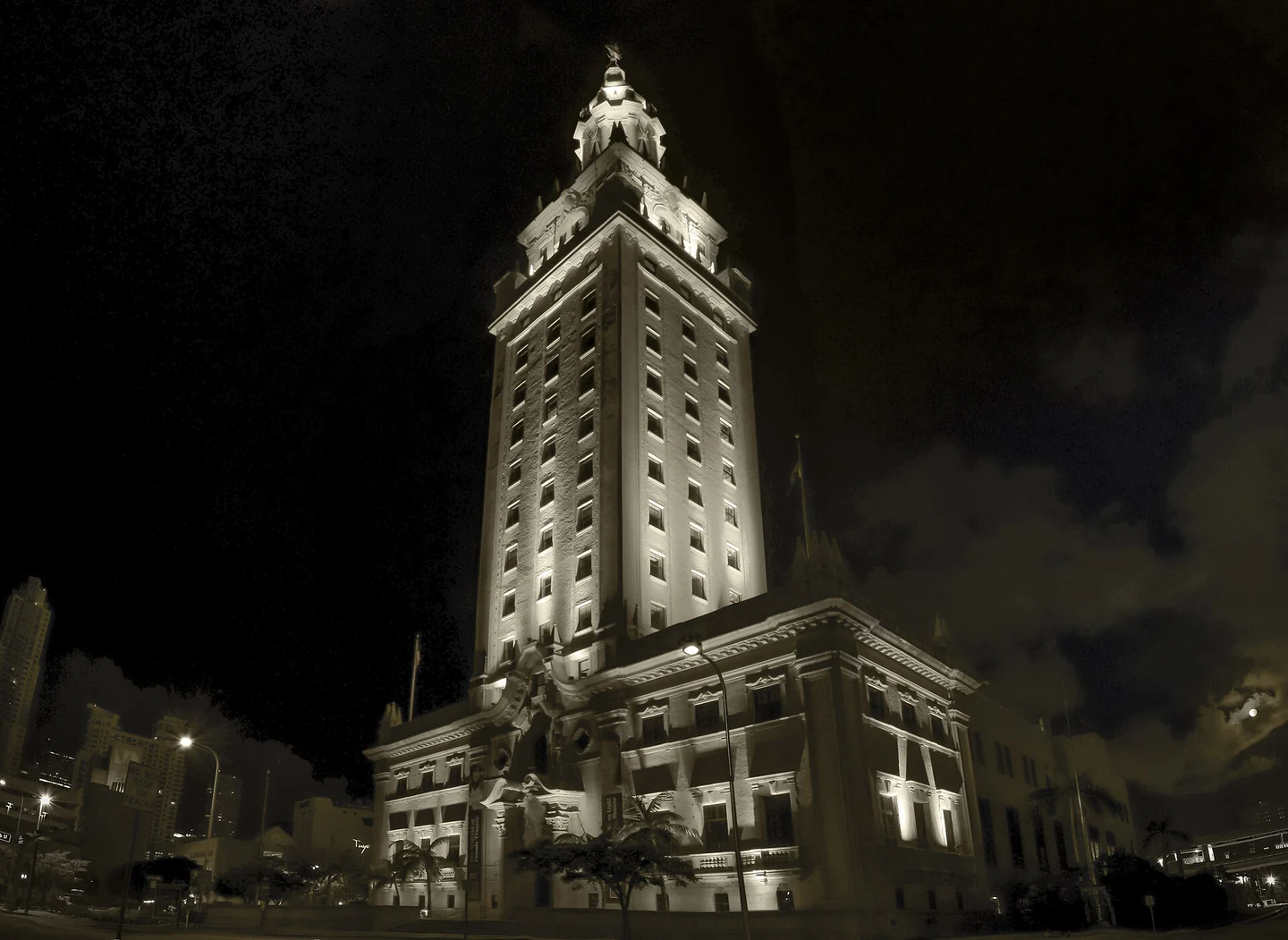 Illuminated Freedom Tower in Miami against a dark night sky