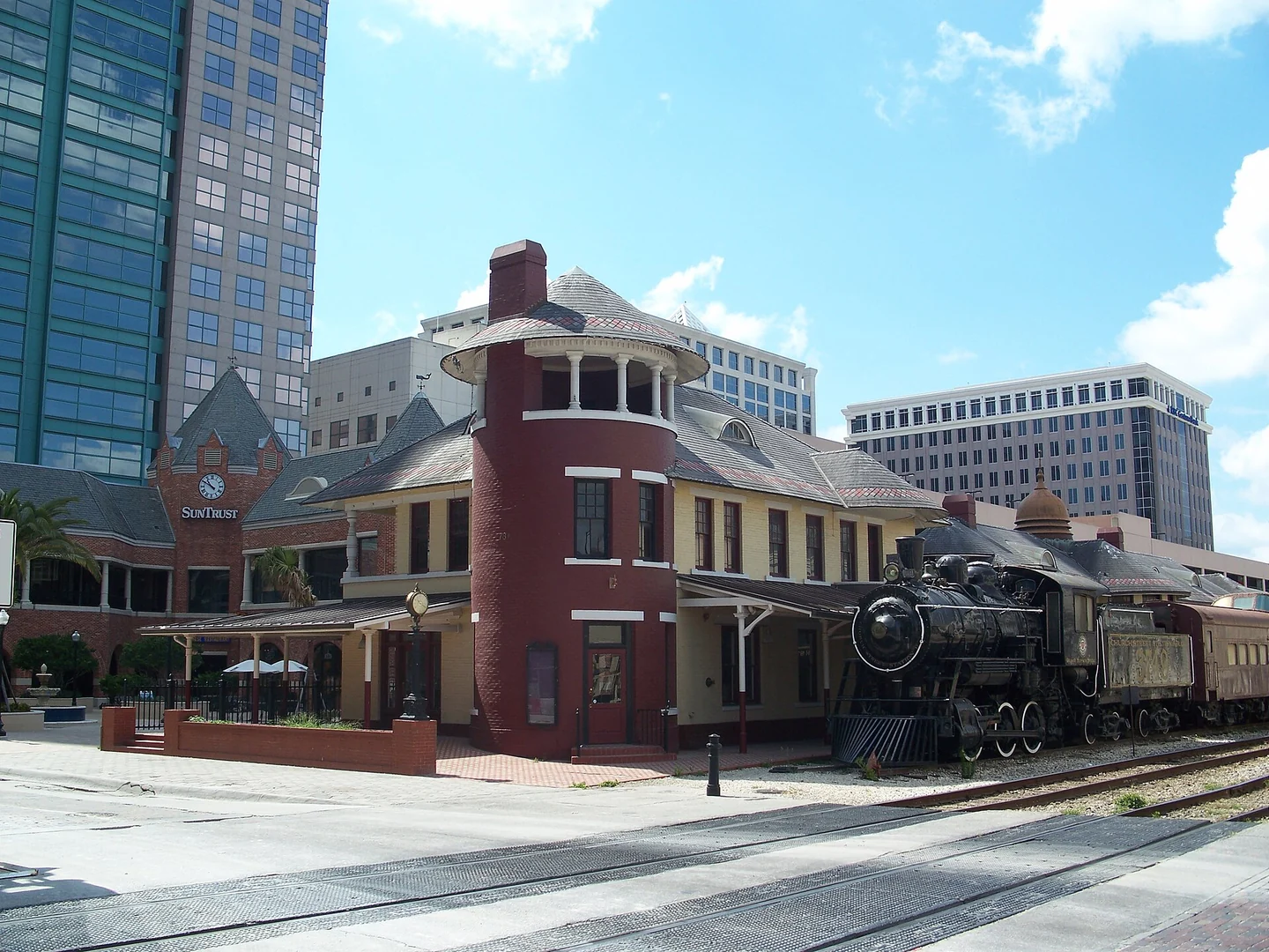 Historic Orlando railroad depot with a locomotive beside the platform