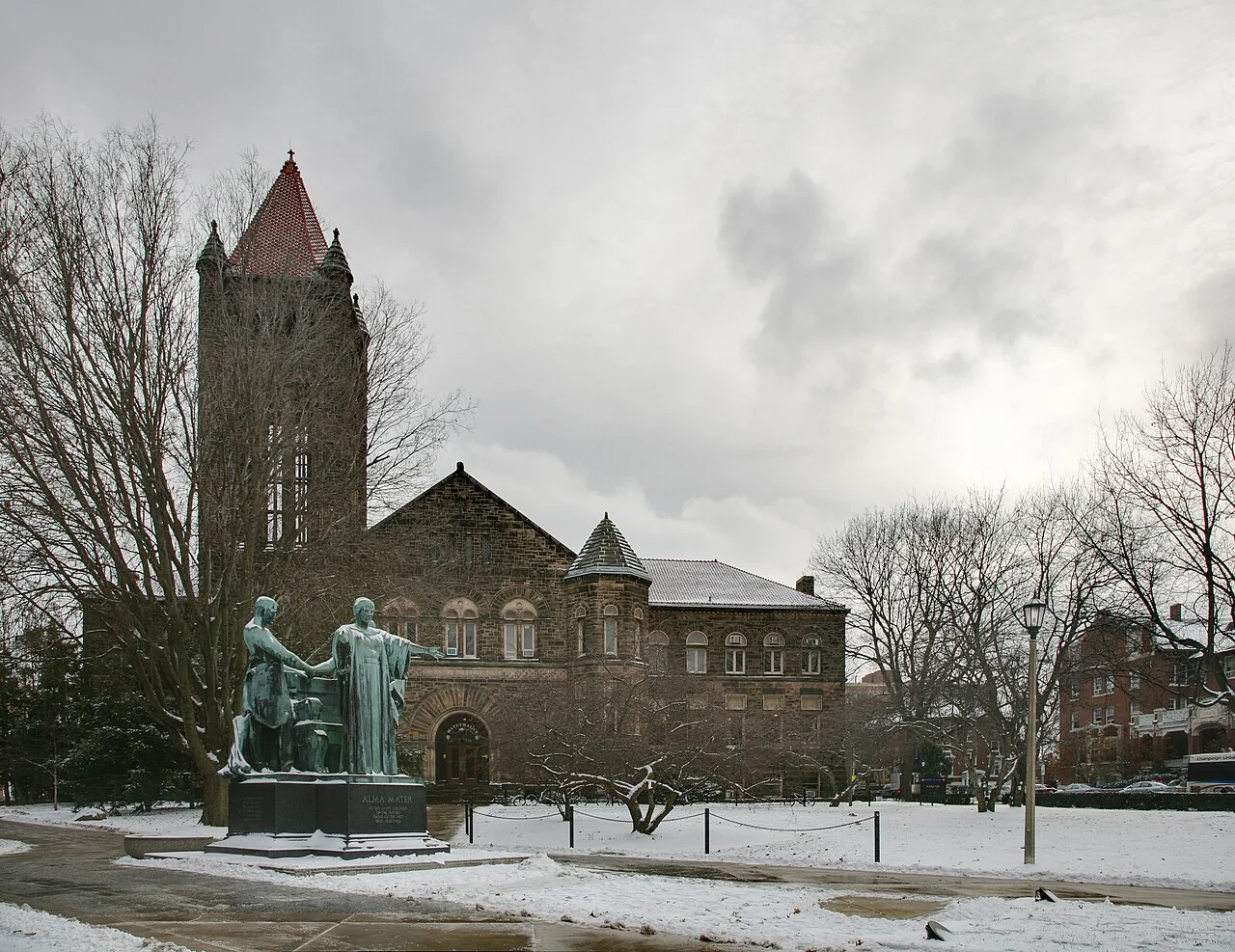 Altgeld Hall’s stone tower and the Alma Mater statue on a winter day.