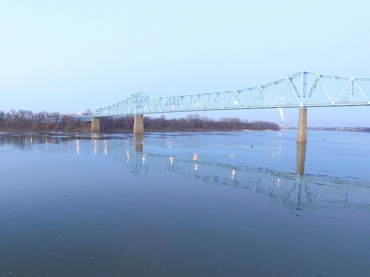 The blue steel Owensboro Bridge reflected in the calm Ohio River.