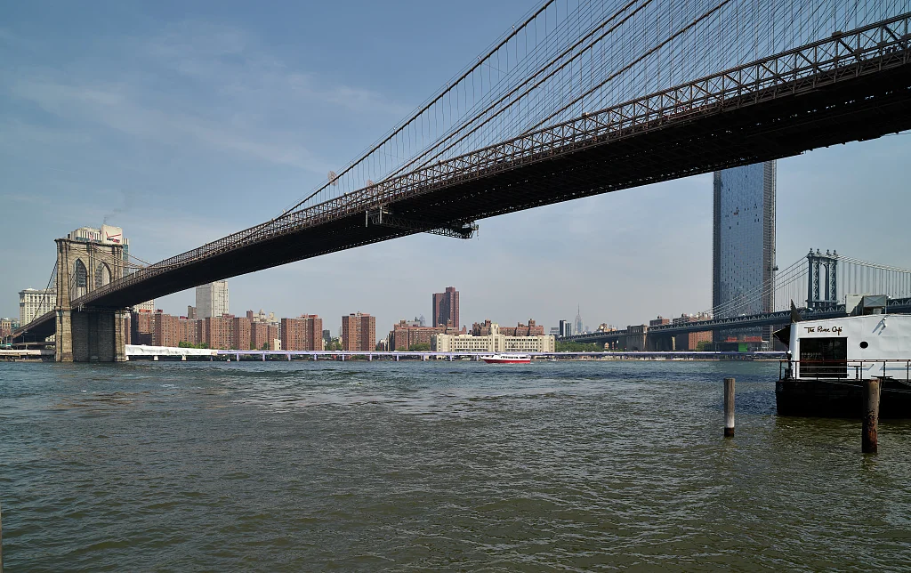 The Brooklyn Bridge and its suspension cables viewed from the Brooklyn waterfront.
