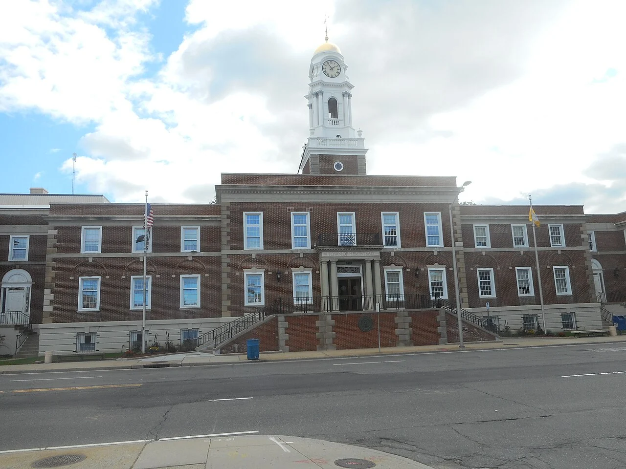 The brick facade and clock tower of Old Hempstead Town Hall on Front Street.